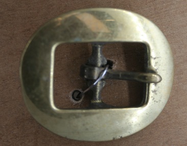 Brass cart buckle used as equine accessory