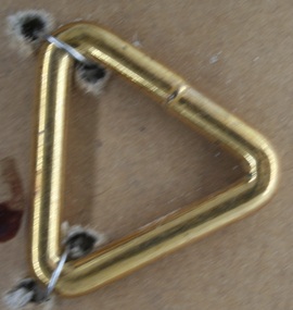 Triangular brass link used in Bridle work by Holden and Frost Ca1900