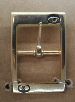 Full buckle with pressed insignia used as equine accessory