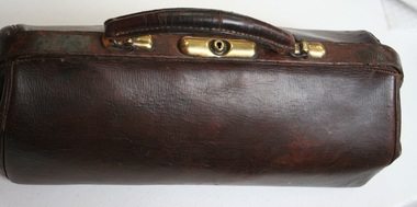 Brown leather brief bag manufactured by Holden and Frost