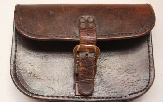 Flapped leather pouch belt mounted. Buckle on front manufactured by Holden and frost