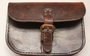 Flapped leather pouch belt mounted. Buckle on front manufactured by Holden and frost
