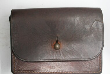 Personal leather pouch lift leather lid fastened in front with brass stud manufactured by Holden and Frost.