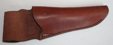 Brown leather knife holder with belt mount at top manufactured by Holden and Frost