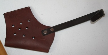 Brown leather axe head protector, with black leather strap with bright metal buckle and studs