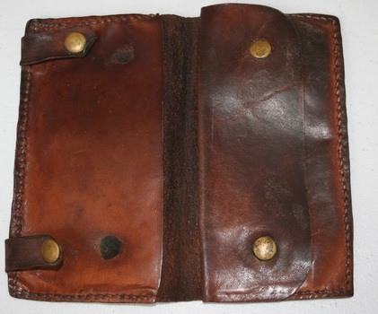 Leather wallet with brass studs and closed coin pocket.