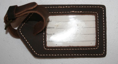 Leather label tag with strap and brass buckle
