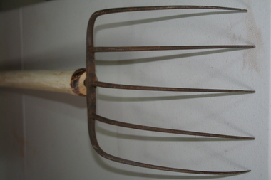 wooden handled five pronged steel agricultural fork