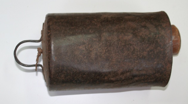 Metal cow bell with wooden clanger , we believe was imported by HOLDEN and FROST