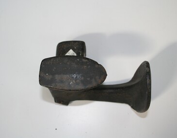 cast iron with two shoe shapes to place shoes on for repair