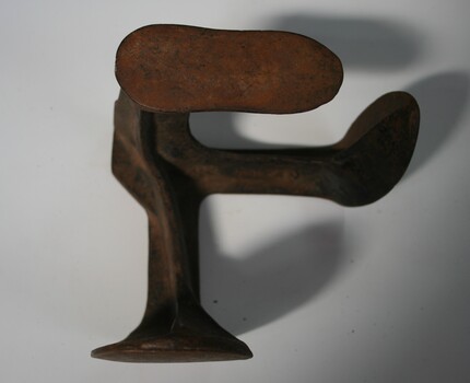 cast iron with three shoe shapes to place shoes on for repair