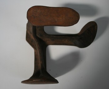 cast iron with three shoe shapes to place shoes on for repair