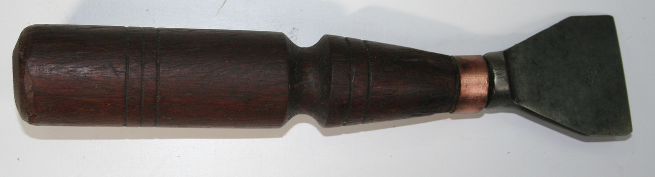 metal chipper with brass head and rosewood handle