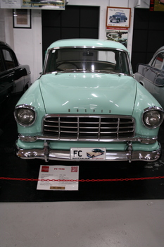 Holden FC model 4 door sedan. Two toned green finish on outer with the darker shade on the roof and rear side panels. Wire scrrwen stone guard covers on both headlamps. Chrome grille with over riders.