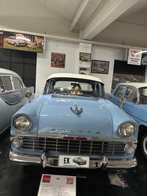 Blue body with white roof. Indicators on the front incorporated into the chrome grille. Chrome bumper with over rider. 