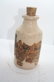 Squat ceramic bottle containing Properts saddle stain for the darkening of Saddles, Bridals, Reins and all leather goods.