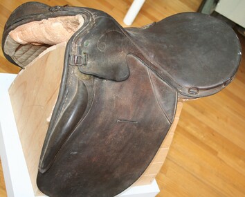 Brown leather equine saddle used circa 1900