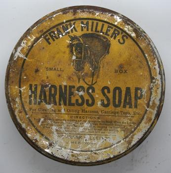 Squat round tin containing a paste of Harness soap