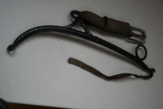 pair of black painted steel Hames with leather strap and steel buckle on leather strap