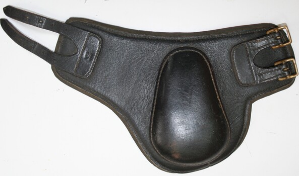 Pair of knee protectors, leather shaped to cover and wrap around knee with two straps and buckles for fastening in position