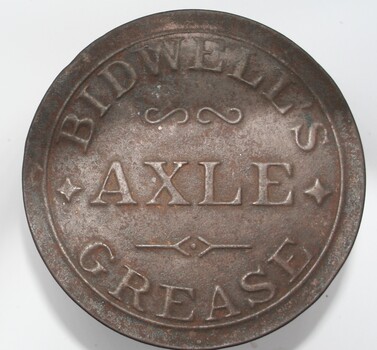 Squat round red painted tin with pressed label on tin lid