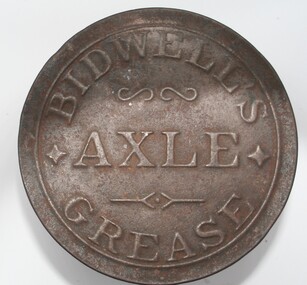 Squat round red painted tin with pressed label on tin lid