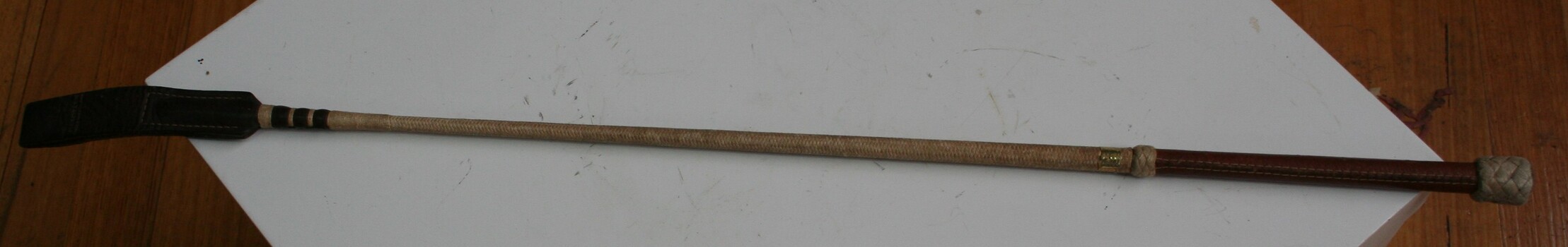 Crop used by riders. Cane shaft with leather handle  and leather tip.