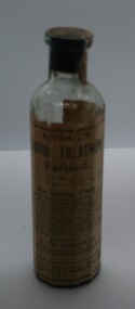 11 sided glass bottle with yellow label with instructions for use