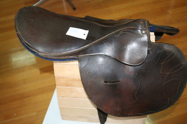 Small leather saddle used for exercising horses
