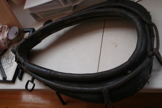 Brown leather collar to go around the neck of a horse to allow  it to haul heavy loads