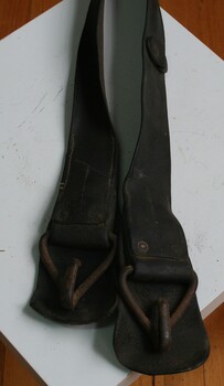 Brown leather belt used for under a horse's belly as part of the harness set