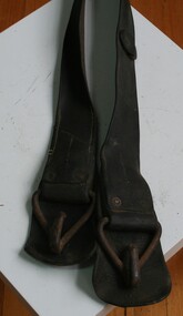 Brown leather belt used for under a horse's belly as part of the harness set
