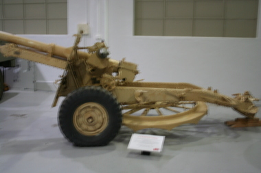 25 Lb cannon painted in desert camouflage paint. Fitted with detachable steel turntable mounted on the underside of tow bar