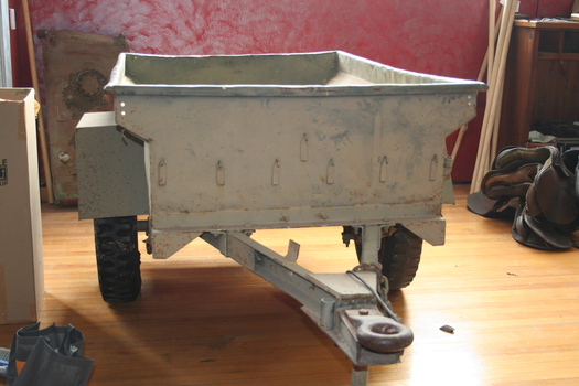 Military trailer painted in camouflage green designed to be towed behind a Willys jeep.