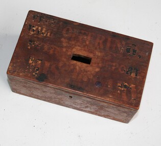 Brown wooden box with slot on top for coins