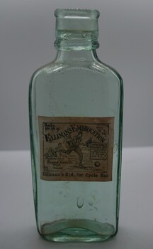 Clear glass bottle with paper label