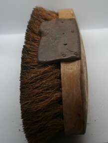 wooden bodied with leather grips both sides, hard bristles. 