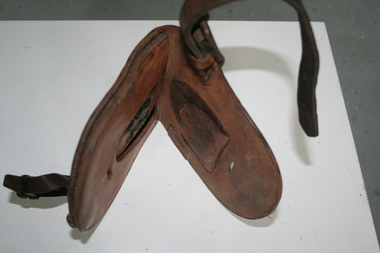 Brown leather pouch folding in centre. Inner pouches to hold horse shoes and nails.