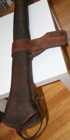 Brown leather gun case designed to be attached to a saddle
