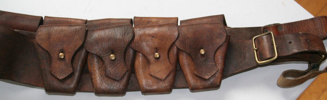 Brown leather ammunition bondelier with nine pouches for holding ammunition