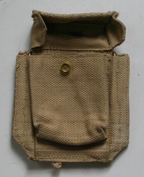 Canvas pouch with canvas lid, press stud fastening. Brass clips on rear for attaching to belt.