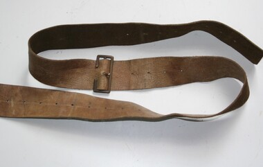 Brown leather strap with holes each end, brass buckle midway