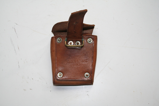 Light brown coloured leather pouch with rear fastening cover, strap inside for holding contents firmly Brass loop and rivets on back.