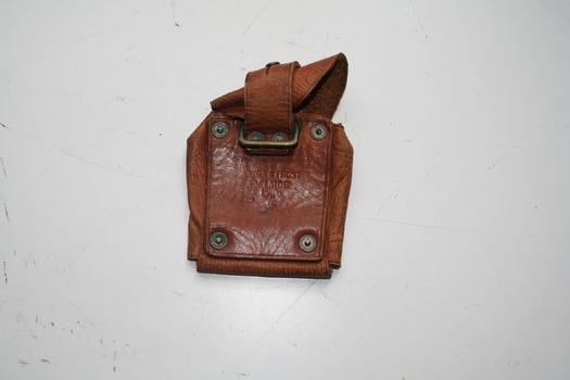 Tan leather ammunition pouch, with strap riveted to rear thus making able to attach to bandolier or belt