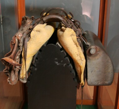 Brown leather pack saddle used for carrying multiple objects