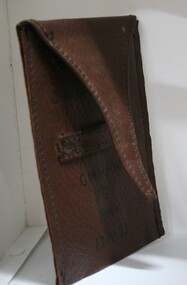 Brown leather pouch with fold over cover/lid. Strip sewn in across face to enable lid to be held closedBrown leather pouch with fold over cover/lid. Strip sewn in across face to enable lid to be held closed