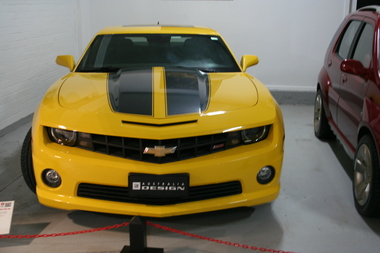 Yellow with black panels on the bonnet of the car