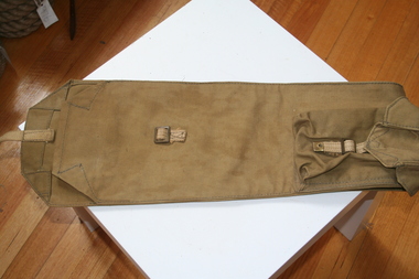 Military green canvas rifle carrier with brass buckle to fasten opening
