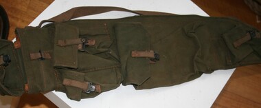 Army green canvas rifle bag. Pouches on the side to carry ammunition, all fastened by brown leather straps