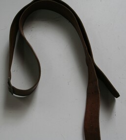 Brown leather belt with holes both ends and centre.